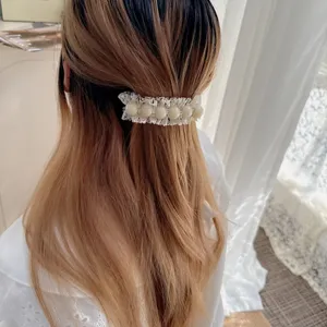 Elegant white lace pearl hair clip detail shot, sweet bow design for daily women wear.
