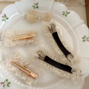 Detail shot of sweet lace hair clips set, elegant floral ceramic plate background.