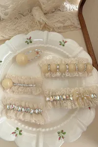 Detail view of sweet lace pearl and rhinestone hair clips, showcasing exquisite bow and mesh design.