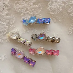 Detailed shot of exquisite crystal rhinestone hair clips, sparkling bow duckbill clips for women.