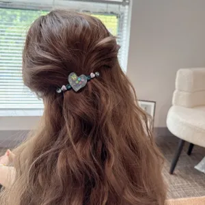 Detail view of a charming heart rhinestone hair clip with cute beaded side design for women.
