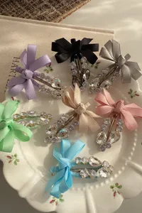 Detailed close-up view of vibrant colorful ribbon bow rhinestone hair clips displayed