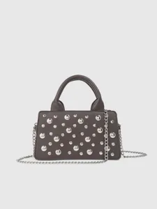 Details of the dark grey punk style studded handbag with metallic chain strap and studs.