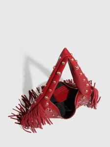 Close-up detail of a red leather fringe shoulder bag featuring stylish gold metal studs.