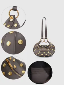 Detailed view of retro punk PU leather shoulder bag with chic gold metal studs and rings.