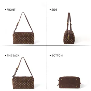 Detail view of brown suede shoulder bag showing gold metal eyelets and adjustable strap.