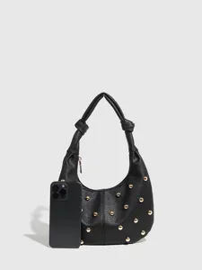 Close-up detail of black leather hobo shoulder bag with chic gold metal studs and knotted handle.