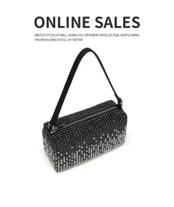 Black rhinestone cylindrical shoulder bag for women, sparkling evening party handbag with strap.