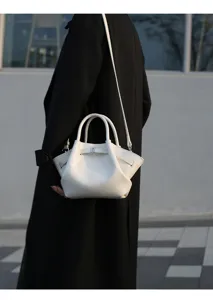 Chic white pleated shoulder bag for women, elegant commuter handbag with top handle and strap.