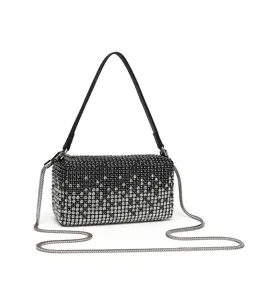 Detailed close-up of luxury black rhinestone crystal evening handbag with metal chain.