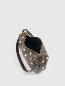Details of the retro punk PU leather rivet shoulder bag showing golden hardware.