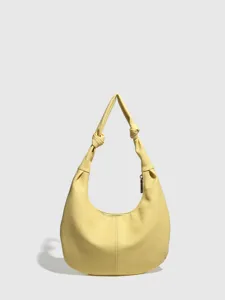 Yellow hobo shoulder bag for women, stylish knotted strap pebble leather casual purse.