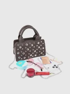 Detailed view of the punk style studded handbag, featuring chic metallic rivets and chain strap.