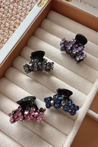 Set of four elegant rhinestone hair claw clips featuring sparkling crystals in chic assorted colors.