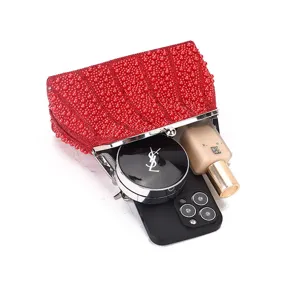 Red beaded evening clutch bag detail showing inner capacity, elegant kiss-lock closure design.