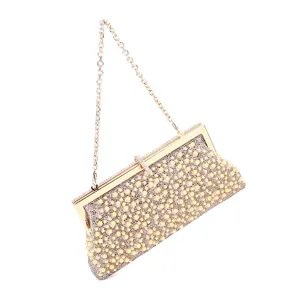 Detail view of elegant rhinestone pearl evening clutch bag with gold chain strap for women.