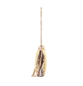Close-up side view of elegant rhinestone and pearl embellished evening clutch bag detail.