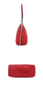 Red pearl evening bag detail view, shimmering sequin clutch with metal clasp and chain strap.
