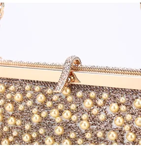 Close-up detail of sparkling rhinestone and pearl evening bag gold clasp luxury women handbag