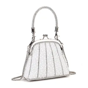 Detailed view of the elegant pearl beaded evening bag with metal kiss-lock handle and chic chain.
