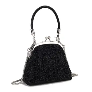 Elegant black beaded evening bag with kiss-lock closure and chain strap for party.