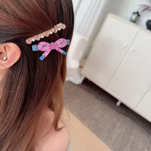 Korean style colorful bow hair clip and rhinestone barrette detail for cute daily hairstyles.