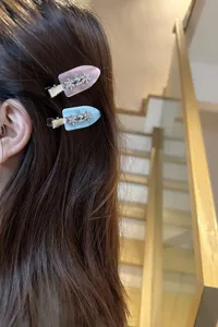 Detail view of cute rhinestone flower acetate duckbill hair clip for daily styling.