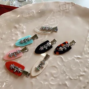 Close-up detail of cute Korean rhinestone floral acetate duckbill hair clips in various colors.