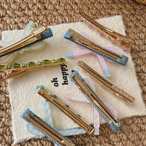 Detailed close-up of colorful dopamine hair clips, featuring denim, crystal, and acrylic bows.