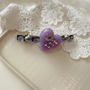 Exquisite purple heart rhinestone hair clip detail with sparkling crystal design.