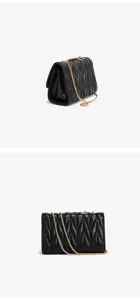 Detailed view of black quilted leather shoulder bag with gold chain strap design.