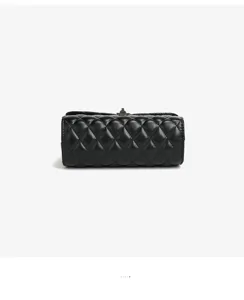 Black quilted leather cylinder crossbody bag with chic metal turn-lock closure fashion.