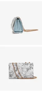 Chic embroidered chain shoulder bag featuring elegant floral pattern and sturdy metal strap detail.