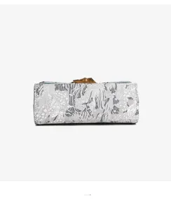 Close-up detail view of the Chinese style embroidered fabric clasp clutch bag texture and metal lock.