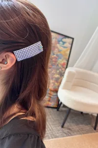 Blue gingham fabric hair clip detail with metal flower accent for women hair style