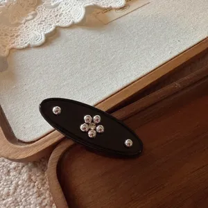 Black acetate hair clip with metallic floral beads, chic retro side duckbill hair accessory.