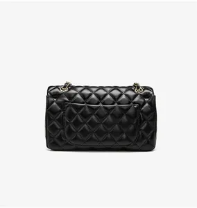 Detail shot of the black quilted shoulder bag showcasing the back pocket and premium texture.