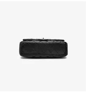 Black quilted leather shoulder bag detail shot, classic luxury flap bag style crossbody purse.