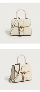 Elegant off-white leather top handle bag with iconic horseshoe buckle, stylish crossbody strap for women.