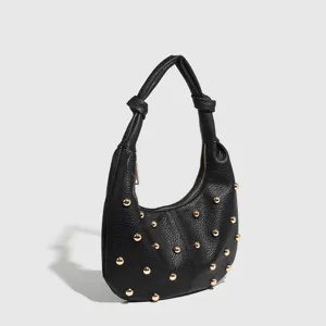 Black studded hobo shoulder bag for women, stylish underarm tote with gold tone hardware.