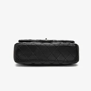 Classic black quilted leather chain bag detail shot showcasing exquisite diamond pattern design.