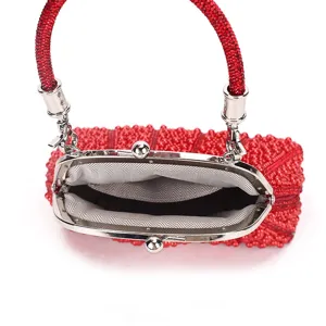 Red beaded kiss-lock evening bag with silver hardware and chic handle for party and banquet.