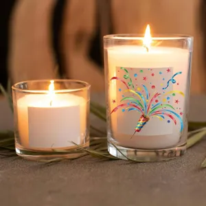 Decorative glass jar candles with colorful party sticker designs for home decor and gifting.