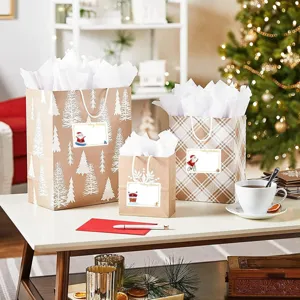 Christmas gift bags set with cute Santa stickers and white tissue paper for holiday presents.