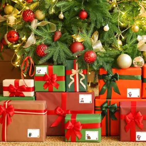 Christmas gift box labels with cute Santa Claus stickers for festive holiday decoration.