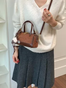 Retro contrast color boston bag for women, chic shoulder crossbody handbag with cute pendant.