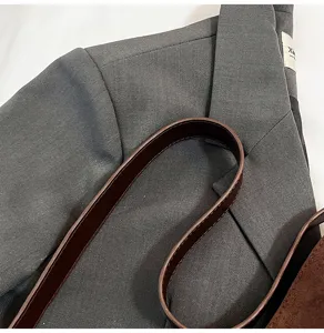 Brown leather crossbody bag strap detail, retro style shoulder bag fashion accessory.