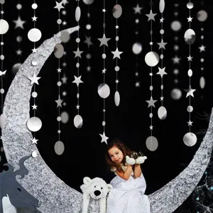 Party hanging paper garland detail featuring silver glitter stars and circles on string.