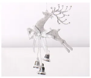 Christmas tree hanging decoration detail, silver glitter reindeer ornament with cute bells.