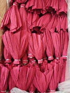 Detailed shot of red crepe paper flowers, pleated paper floral decorations for parties.